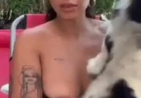 The cat struggled so hard that the owner’s nipple showed up