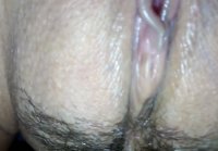 He strokes his wife's shaved pussy with his fingers and takes close up