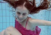 Cheerful and playful Anna swims under water in negligee and thongs