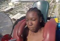 A black woman's tits almost fell out on an attraction