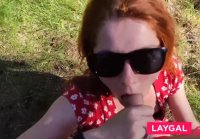 Kinky redhead with big tits gives a blowjob outdoors