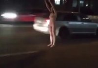 A completely naked girl walked on the highway in Kiev Ukraine