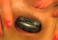 Shoving a mobile phone into the anus close-up