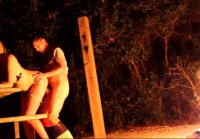 Couple makes sexual intercourse outdoor by the campfire