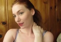 Gorgeous redhead strips and rubs her pussy