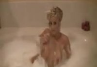 Blonde takes a bath with foam