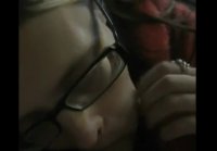 A woman with glasses licks her husband toes and sucks his dick